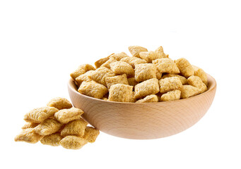 corn pillows pouring out of wooden bowl isolated on white background.