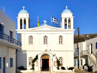 Exterior view of the Holy Church of Zoodochos Pigi in Parikia, Paros, Greece, featuring whitewashed Cycladic architecture, located near the island’s main port.