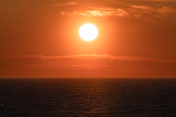 Beautiful orange sunset over the calm waters of the Baltic Sea. Picturesque seascape, an ideal...