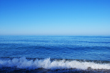 Beautiful sky above the sea, rocky seashore, pebbles on the sea bottom, nature.