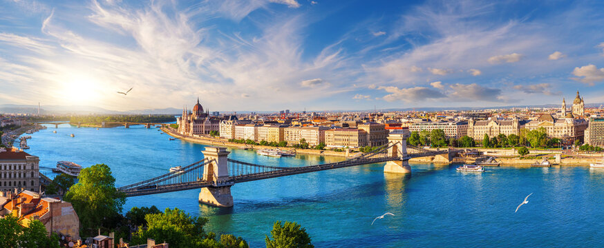 Panoramic view of famous Chain Bridge and Budapest landmark at sunset over Danube river