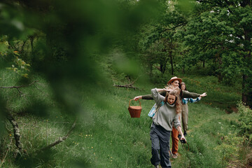 Active middle age woman enjoying a healthy outdoor walk with family in green nature, promoting fitness, wellbeing, and longevity through community connection and wellness.