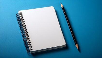 a blank spiral notebook with a black border and a pencil on a blue surface in a studio shot