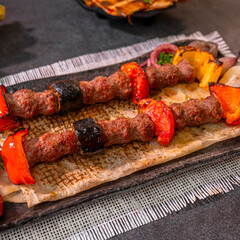 Grilled Middle Eastern Kebab Skewers with eggplant , Served on Flatbread with Tahini Sauce