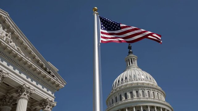 United states flag waving proudly in the wind, with the iconic dome of the us capitol building in the background, a symbol of american democracy and government