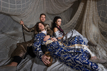 Fototapeta premium Middle Eastern fairytale group shot, models in luxurious Arabic attire against exotic backdrop