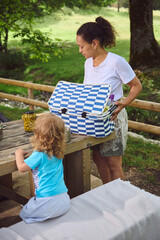 Family Enjoying a Picnic Outdoors in a Scenic Mountain Park Setting