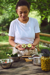 Woman Preparing Fresh Ingredients for Outdoor Cooking with a Natural and Peaceful Backdrop