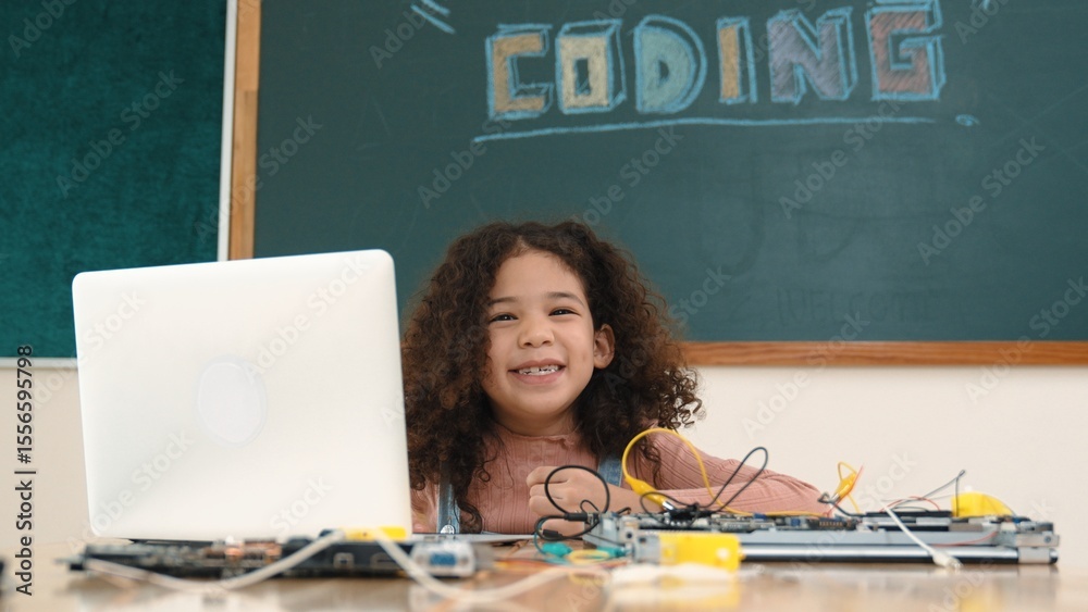 Poster attractive african student programing system while looking at camera. american girl working on her l