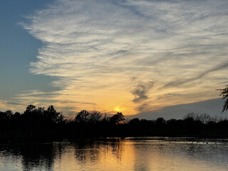 Golden Haze Over a Quiet Lake at Sunset