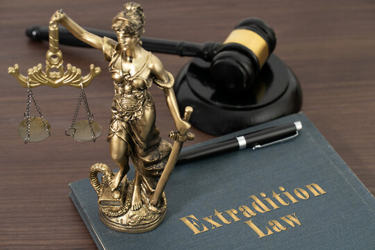 A gavel, Lady Justice, and a book titled Extradition Law &mdash; powerful symbols of legal authority, justice, and the international process of holding fugitives accountable