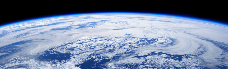 Earth from space showing massive hurricane storm system with swirling clouds. Satellite view of planet.