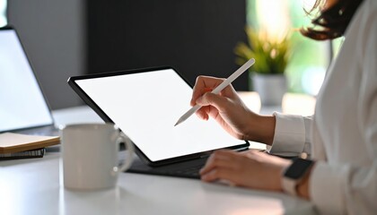 Person Using Touchscreen Tablet with Stylus in Modern Workspace Setting