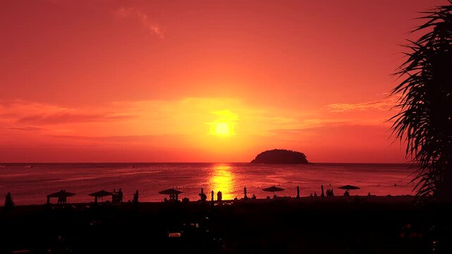 People enjoy tropical island beach during sunset in Krabi, Thailand