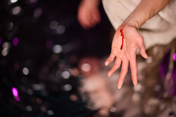 Artistic and Creative Representation of a Bloodied Hand in Dramatic Lighting and Shadows