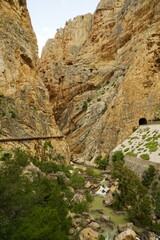The famous El Caminito del Rey in Malaga with its amazing views with trees, mountains, river and a...