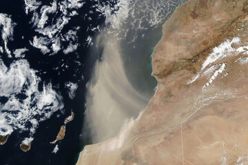 A vast Saharan dust plume drifts from Morocco over the Atlantic Ocean, visible from orbit. Image courtesy of NASA © Bluee
