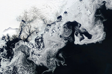 Swirls of sea ice off the coast of Greenland seen in a satellite image from space. Image courtesy of NASA.