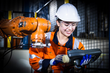Asian development technician engineer testing artificial intelligence robot arm at high technology...
