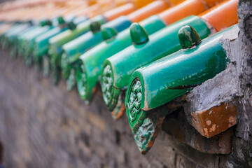 The blue glazed tiles on the wall as the background, the traditional architecture