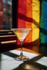 A Cocktail in Front of a Rainbow Pride Flag