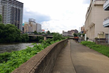 Fototapeta premium June 28, 2025, Morioka, Iwate Prefecture, Japan.View of the Kitakami River and downtown area.