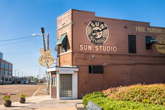 Memphis, TN - USA: Exterior of Sun Studios at mid-day, bright sunshine, bright blue sky, showing entrance from the side with Sun logo, large guitar, sidewalk.