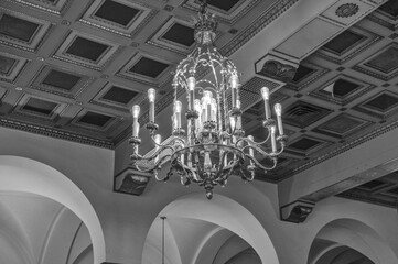 Gold Chandelier with a Art Deco Ceiling Background in Black and White.