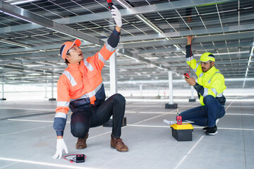 Electrical engineers are inspecting and installing a solar panels on the building rooftop.