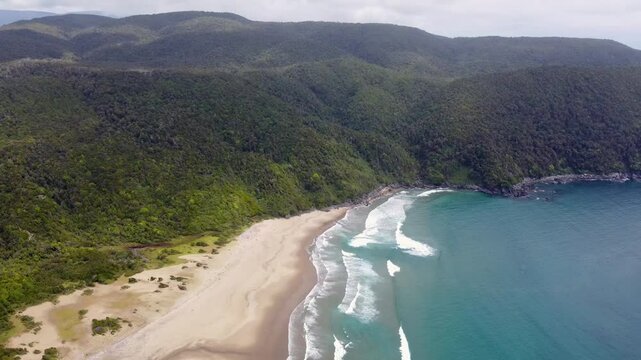 Scenic aerial footage of wild beach and ocean in southern Chile. Rada Ranu, waves, forest and coastline seen from above