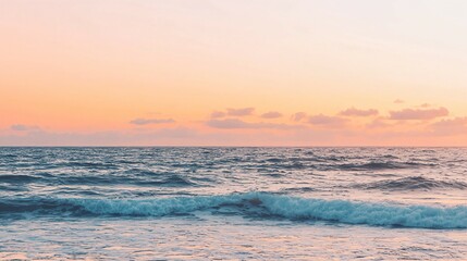 Obraz premium Caribbean sunset with orange and pink hues, calm waves, and a clean horizon, evoking serenity and natural beauty.