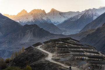 Sunrise over a mountainous landscape with solar panels in the foreground, highlighting the blend of...