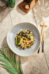 Wok-fried wild rice with vegetables, shrimp, and egg, bright overhead composition