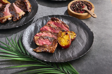 Bavette steak alternative cut with roasted potato, bright rustic lighting, overhead composition