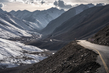 Mountain Road Winding Through a Snow-Dusted Valley