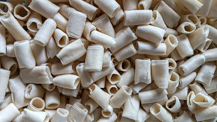 Raw spring roll wrappers used in making Kuih Batang Buruk, a traditional Malaysian snack. Fried,...