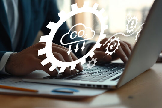 Business Person Using Laptop with Cloud Computing Concept and Eco-Friendly Elements Representing Carbon Emission Reduction Strategy in Modern Workspace