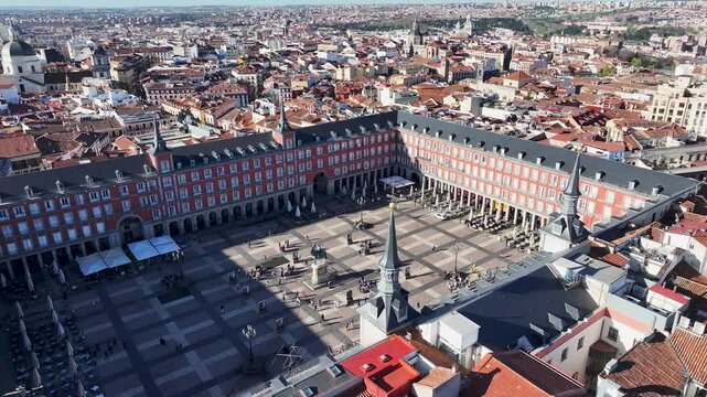 Plaza Mayor In Madrid Spain. Aerial View Of A City Park Surrounded By Busy Streets And Buildings. Business Clouds Sky Downtown Cityscape. Business Backgrounds Panning Wide. Madrid Spain.