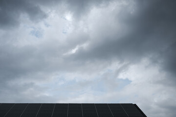 A cloudy sky with a solar panel on top
