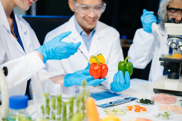 Team of scientists examining food samples in a lab with microscopes. Perfect for themes of food science, biotechnology,