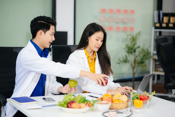 Doctors sharing fresh vegetables, promoting health and nutrition. Ideal for wellness, healthcare,...