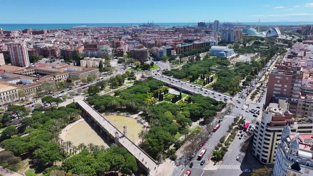 Turia Gardens In Valencia Spain. Aerial View Of Green Space Surrounded By Lush Forest Trees. Town Sky Backgrounds Urban. Town Outside Downtown Panning Wide. Valencia Spain.