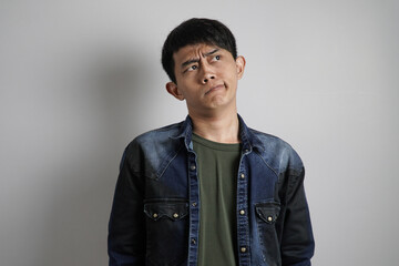 Fototapeta premium a confused young Asian man
