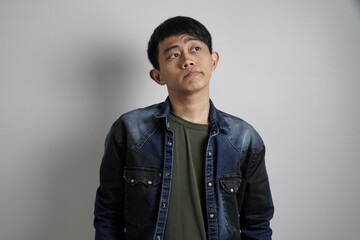 a confused young Asian man