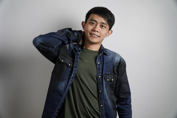 Smiling Asian Man with Hand Behind Neck