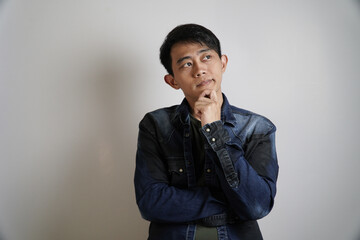 Thoughtful Asian Man with Hand on Chin
