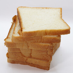 A stack of eight white bread slices against a white background.