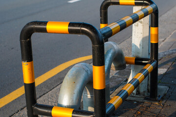 Black and yellow striped safety barriers provide clear delineation beside a road with a visible...
