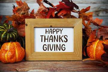 Thankful, Grateful, Blessed text with maple leaf decoration on wooden background