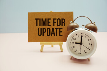 Time for Update text on paper card with alarm clock on pink background